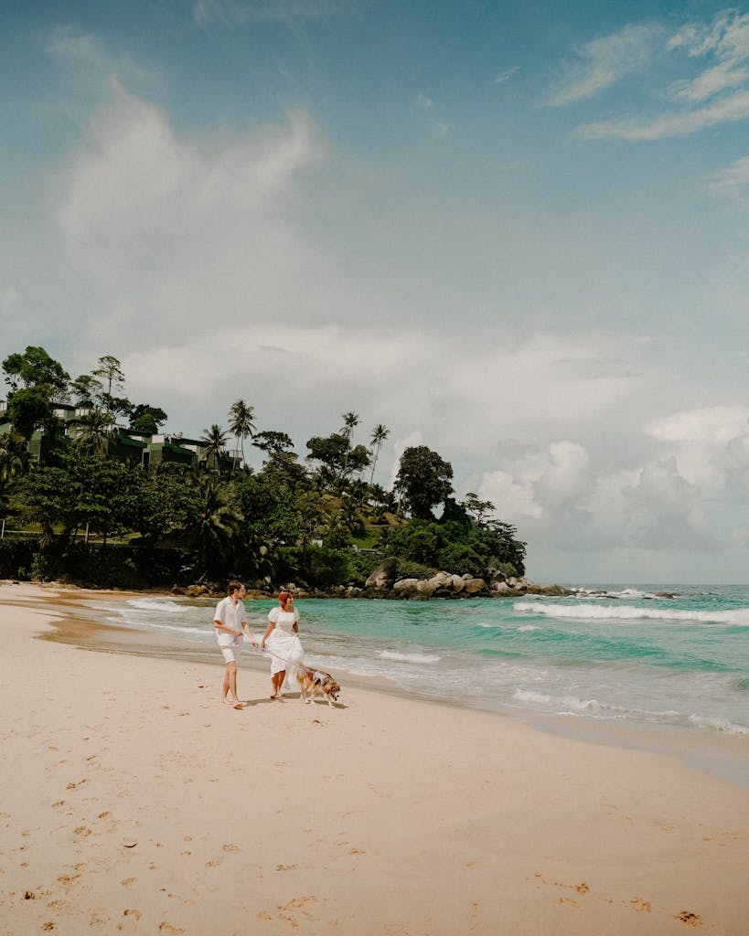 Romantic walk with a dog on a scenic tropical beach in Phuket, Thailand.