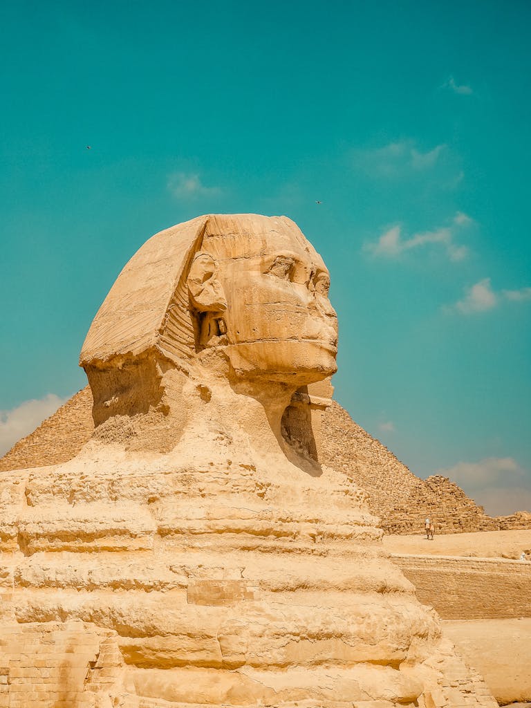 Stunning view of the Great Sphinx and Pyramid under a clear blue sky in Cairo.